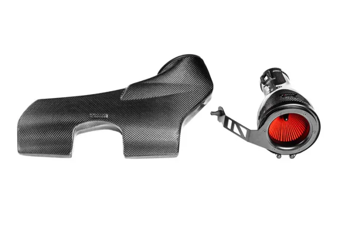 Carbon fiber car engine air intake system with a red filter and a matching cover, isolated on a plain white background.