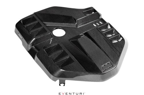 Carbon fiber engine cover with a central circular cutout, intricate geometric patterns, and text "EVENTURI" below, isolated against a white background.