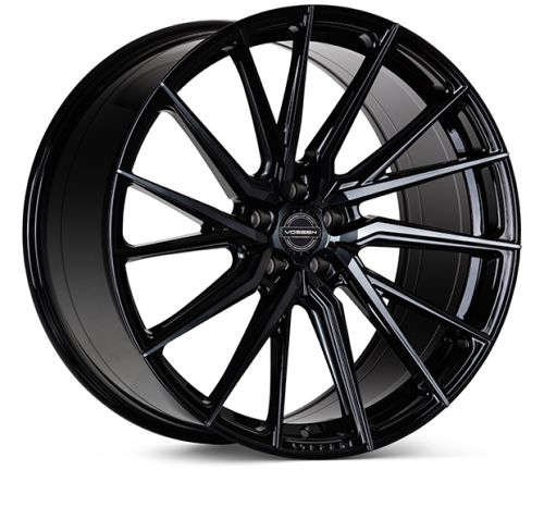 A sleek, glossy black alloy wheel with multiple thin spokes arranged in a radial pattern. Text at the center reads, “VOSSEN FORGED.” The wheel is set against a white background.