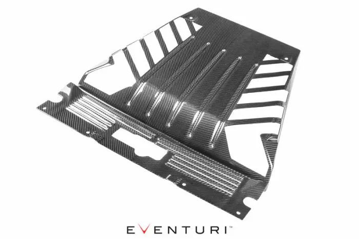 A carbon fiber car part sits on a flat surface, featuring vented slats and mounting holes, with the brand name "EVENTURI" displayed below.