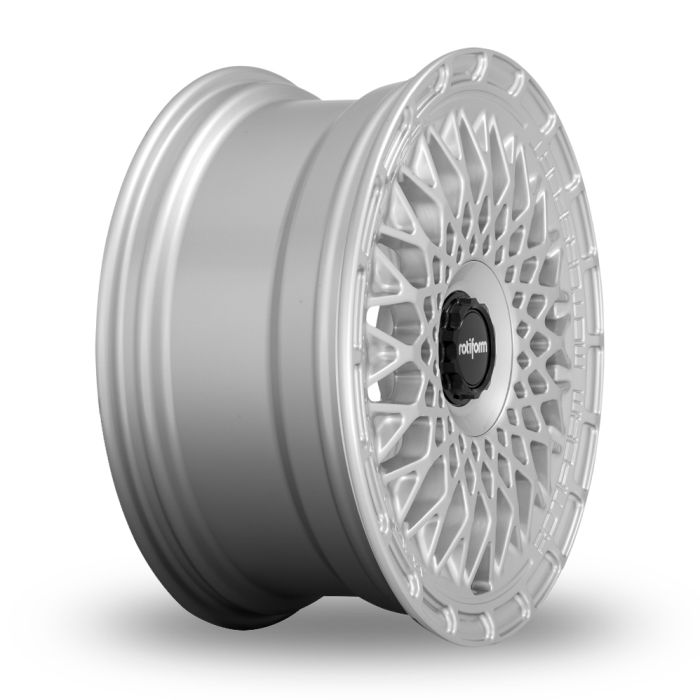 A silver car wheel rim with intricate, geometric spokes and a central black cap displaying the text “rotiform,” against a plain white background.