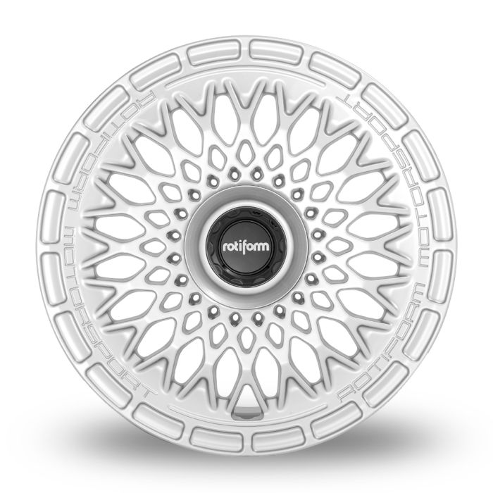 A white, intricately designed alloy wheel with "rotiform" on the black center cap and "ROTIFORM MOTORSPORT" embossed on the outer rim, set against a plain white background.