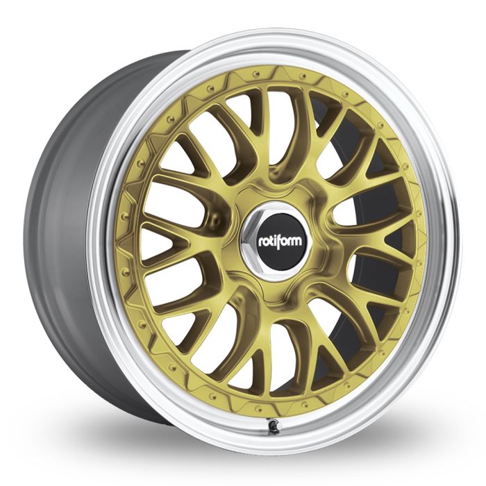 Gold mesh-style car wheel rim with a polished silver lip, black center cap featuring the text "rotiform." Rim is set against a neutral white background, highlighting its elegant design.