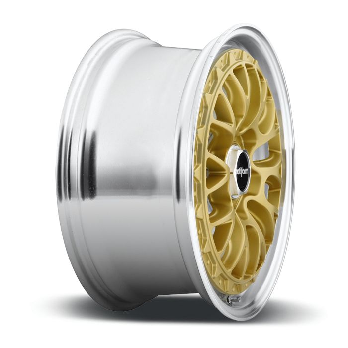 A gold alloy car wheel rim with intricate spoke design and a silver outer lip rests on a white background. The center cap reads "rotiform."