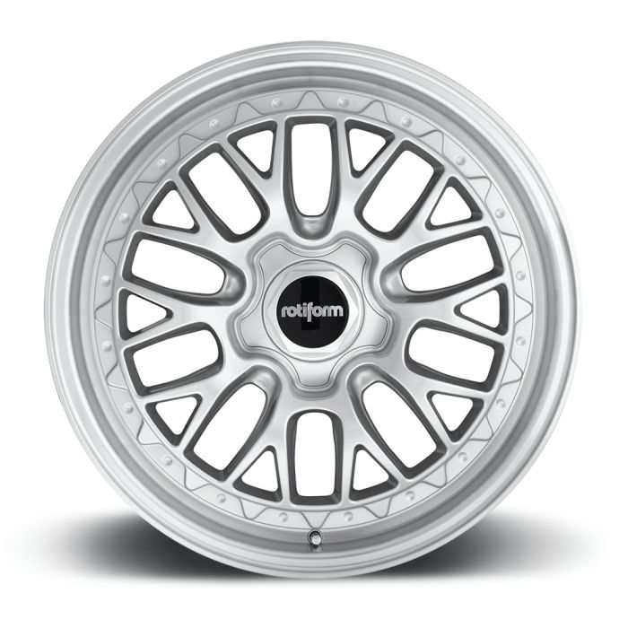 A silver alloy car wheel with intricate multi-spoke design and the center cap labeled "rotiform" on a black background, set against a plain white backdrop.