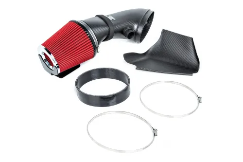 Red cylindrical air filter with black intake pipe, surrounded by carbon fiber shield, and two metal clamps on a white background.
