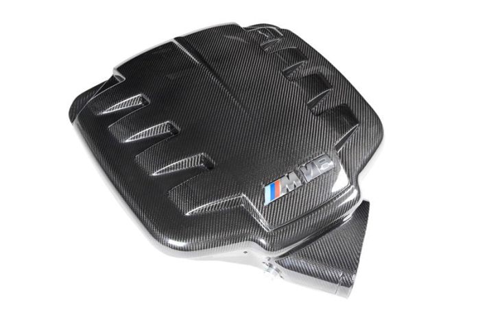 Carbon fiber engine cover labeled "M V8" with vent-like ridges, placed on a white background.