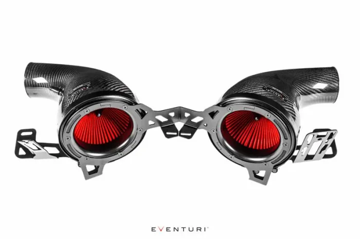 Two carbon fiber air intake tubes with red filters are mounted on a metal frame, shown against a white background. Text: "EVENTURI."
