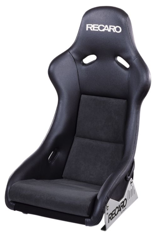A black Recaro racing seat is displayed on a plain white background, featuring a reclining design with side support bolsters, high backrest, and padded seating for comfort and safety.