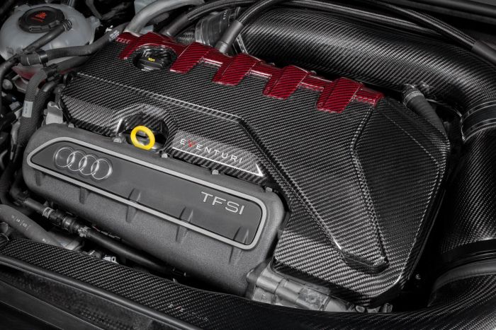 A carbon fiber engine cover with "EVENTURI" text sits over an Audi TFSI engine in a vehicle's engine bay, surrounded by various tubes and components.