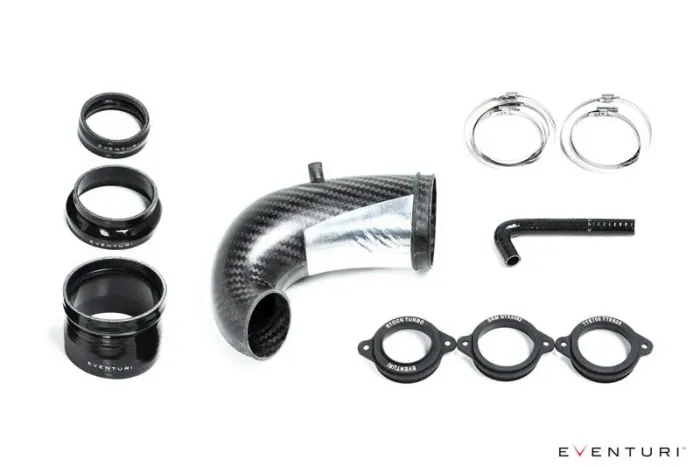 A set of automotive components including a carbon fiber intake pipe, three black hose adapters, two metal clamps, a small angled hose, and three turbo flanges, labeled "Eventuri."