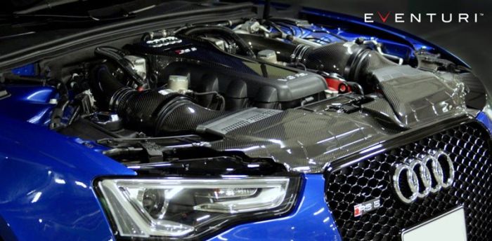 Car engine bay featuring a high-performance engine with carbon fiber components, located in a blue Audi RS5, with "EVENTURI" logo in the upper right corner.
