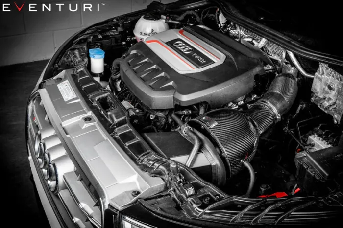 Engine components with "Audi TFSI" branding are visible inside a car's open hood, featuring a carbon fiber Eventuri air intake system. Text reads "EVENTURI™" in the top left corner.