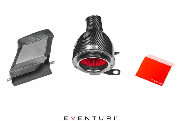 Eventuri carbon fiber air intake components laid out on a white background: a vented box (left), a cylindrical air filter with red interior (center), a flat red panel (right). Text: "EVENTURI".