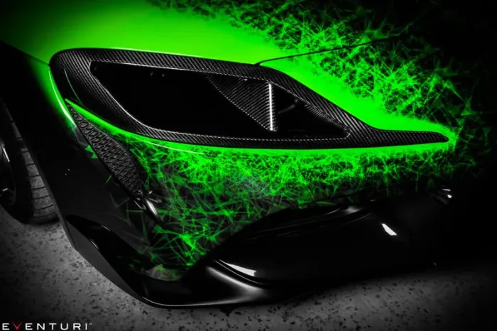 A black sports car with carbon fiber accents and vibrant green light streaks is parked on a textured surface. The brand name "EVENTURI" is displayed in the bottom-left corner.