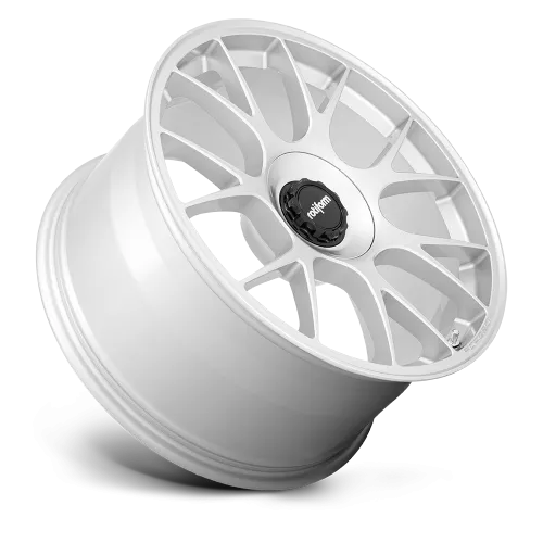 A white, multi-spoke alloy wheel rests against a white background. The wheel's central cap features a black and white logo with the text "rotiform" in lowercase letters.