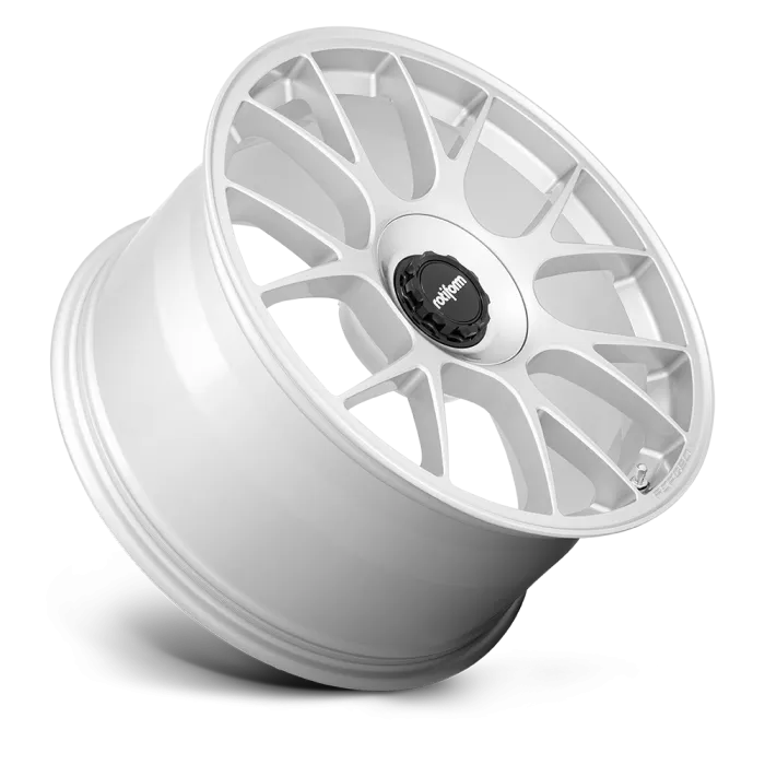 A white, multi-spoke alloy wheel rests against a white background. The wheel's central cap features a black and white logo with the text "rotiform" in lowercase letters.