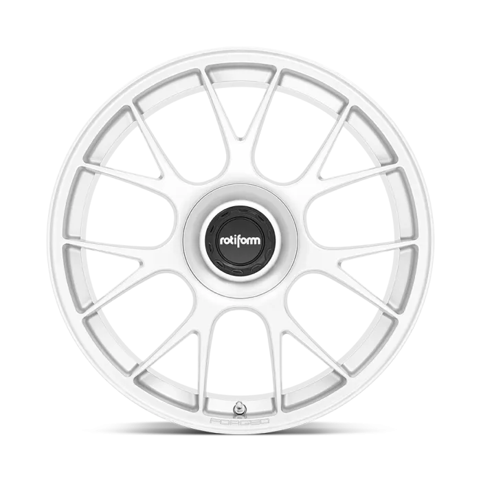 A white car wheel rim with a multi-spoke design; at the center is a black hubcap bearing the text "rotiform." The bottom of the rim is labeled "FORGED."