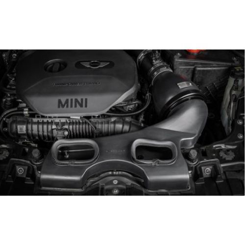 A MINI engine sits stationary within a car's engine bay, featuring a prominent "TWINPOWER TURBO" and "MINI" label on the engine cover.