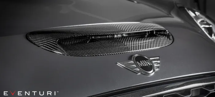 Carbon fiber air vent on a MINI car hood, viewed up close, with the logo prominently displayed below. Text "EVENTURI" appears in the bottom-left corner.