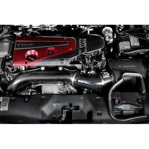 A red and black carbon fiber engine cover with the text "EVENTURI" sits within a car engine bay, surrounded by various engine components, pipes, and wires, with a visible battery on the right.