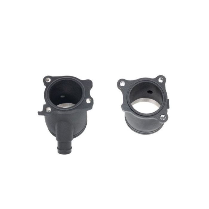 Two black plastic cylindrical fittings, one with a side outlet, are positioned side by side on a white background. The fittings have metal interior linings and four bolt holes on their flanges.