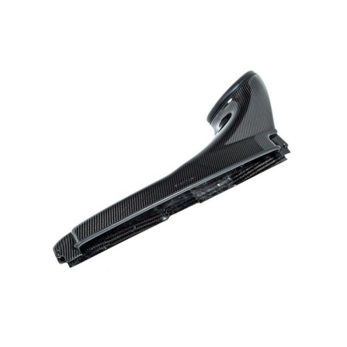 A sleek carbon fiber automotive part with a ridged surface, featuring a curved upper section and a flat lower edge, positioned against a plain white background.