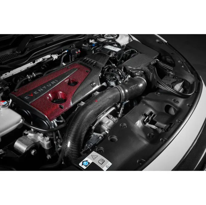 An engine bay features a carbon fiber air intake system and a red carbon fiber valve cover labeled "EVENTURI," surrounded by various mechanical components and hoses.