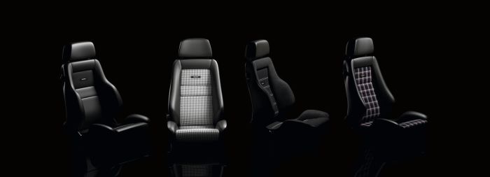 Four car seats in different designs are displayed against a black background. The second and third seats have logos reading "Porsche" and "RECARO," respectively.