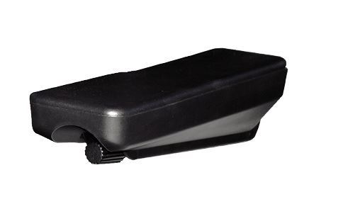 A black plastic rectangular case with a small wheel, resting on a white surface, possibly a guitar capo or clip.