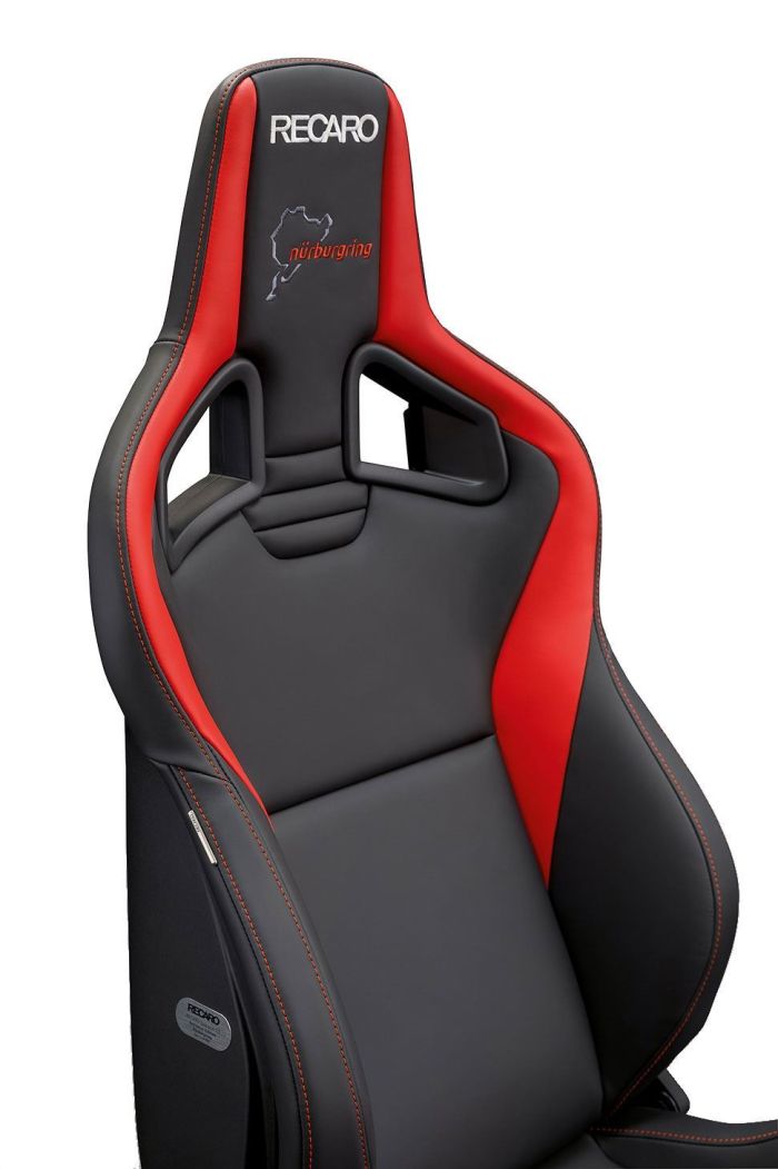 A Recaro-branded, black and red racing seat with Nürburgring logo embroidery, featuring side bolsters and shoulder harness slots, situated in an isolated, white background.