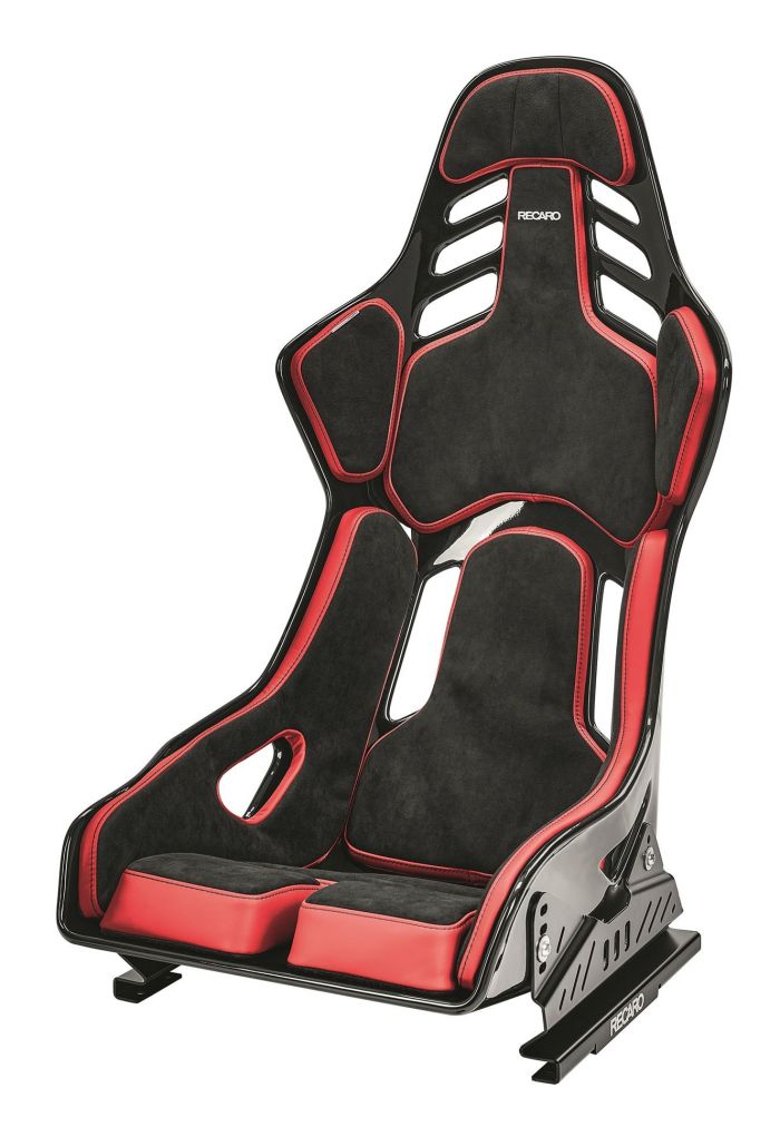 A black and red racing seat with padding and cut-out slots for harness belts. It's designed for optimal support in high-performance driving, featuring "RECARO" branding on the backrest.