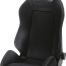 Black Recaro racing seat with white stitching, featuring side bolsters and an integrated headrest, in a plain, white background setting. Text: "RECARO" at the top of the seat.