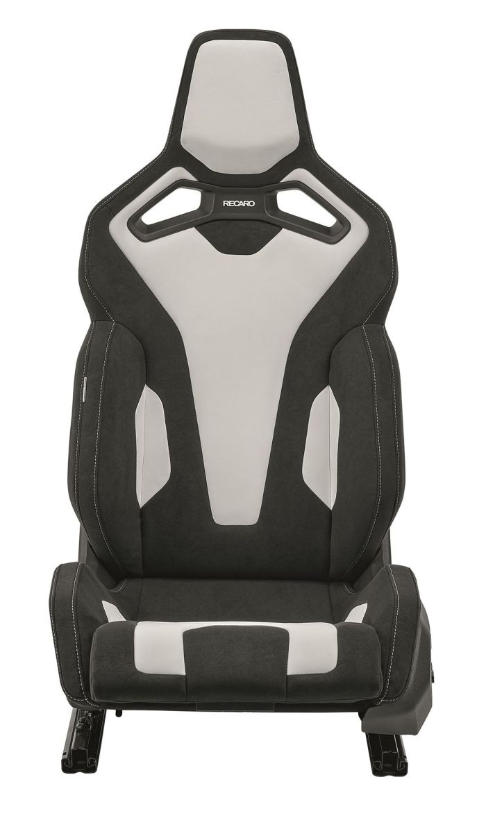 Black and white high-back racing car seat labeled "RECARO," positioned in an all-white background setting. The seat features distinct cushioning and cutout designs for enhanced support and aesthetics.