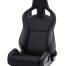 A black racing car seat with integrated headrest and side bolsters stands isolated on a white background. The word "RECARO" is embossed at the top center.