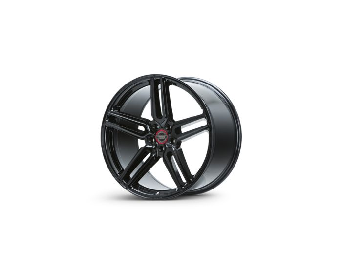 A sleek black alloy wheel with five spokes rests upright, displaying a red center emblem on a plain white background.