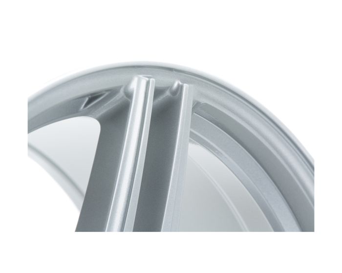 A close-up of a silver alloy wheel rim features two prominent spokes, with a smooth, metallic surface, captured against a plain white background.