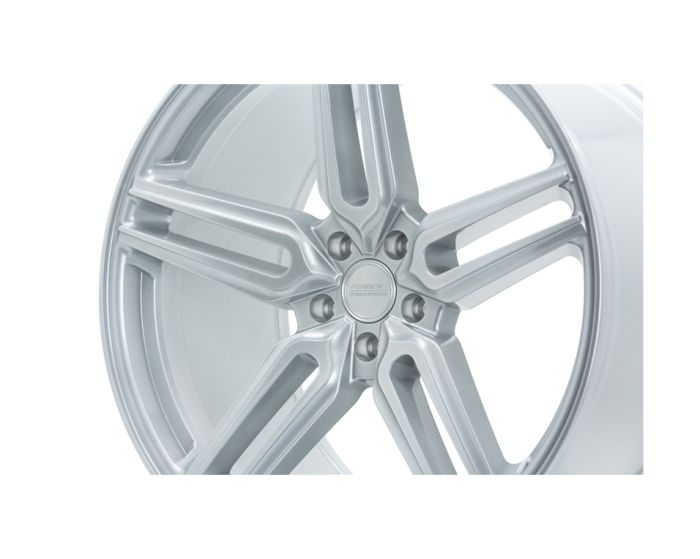 A silver alloy wheel with five spokes is featured, displaying the "HRE FORGED" logo at the center, set against a plain white background.