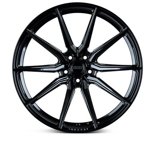 A sleek, black, multi-spoke alloy wheel lies stationary against a plain white backdrop. Center hub features the word "VOSSEN."