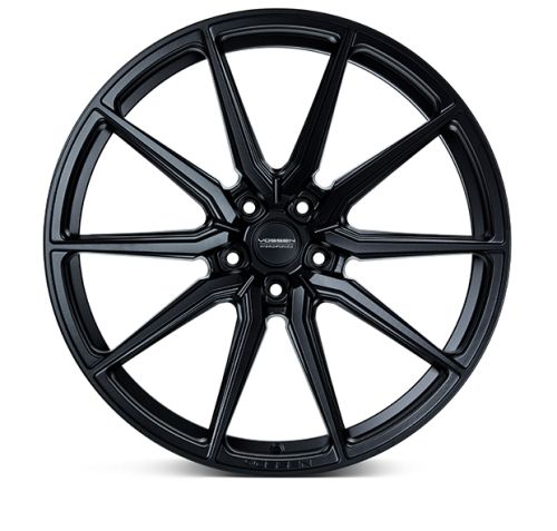 A black alloy wheel features intricate spoke design, resting against a plain white background. Center cap reads "VOSSEN FORGED," highlighting the brand and production style.