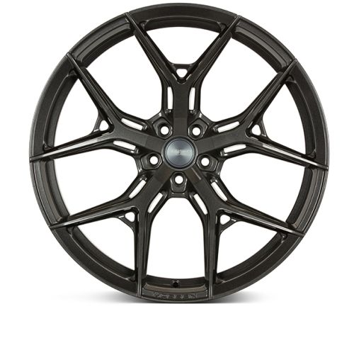 A black alloy wheel features a multi-spoke design in a studio setting, isolated against a white background. No visible text.