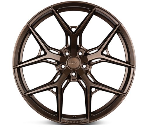 Bronze alloy wheel with intricate, multi-spoke design sits against a white background. Central hub displays text: "HRE" and "0861FM."