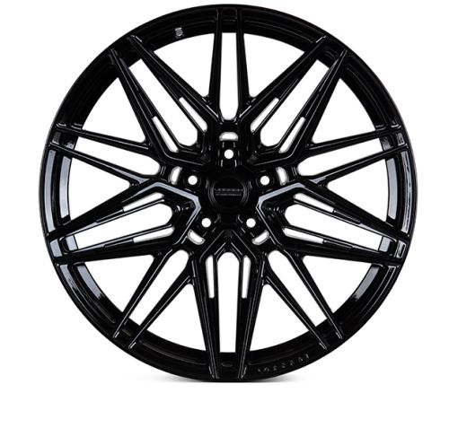 A glossy black automotive wheel features a complex, intersecting spoke design set against a white background. The center cap displays the text "Vorsteiner."