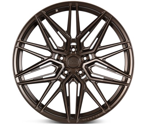 A bronze alloy wheel with intricate, multi-spoke design is placed against a white background. Center cap text: "Vossen Forged." Outer edge text: "VFS-2."