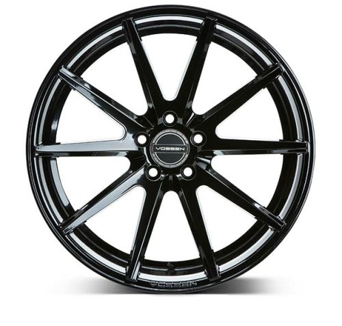 A black, multi-spoke alloy wheel features the brand "Vossen" inscribed at its center, set against a plain, white background.