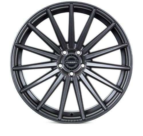 A matte black alloy wheel features multiple slim spokes radiating from the center hub. The hub displays the text "VOSSEN FORGED." The background is plain white.