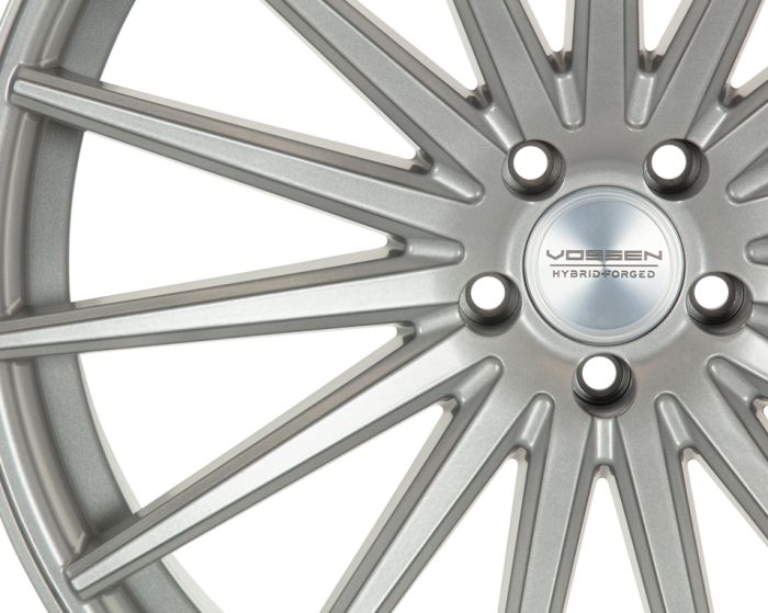 Silver alloy wheel with ten angular spokes radiating from a hub. Center cap displays "VOSSEN HYBRID FORGED." Wheel holes are evenly spaced around the hub.